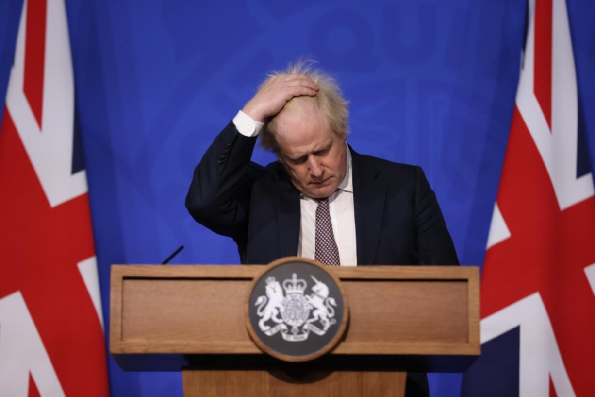 Britain's Prime Minister Boris Johnson gestures as he speaks during a press conference in London, Saturday Nov. 27, 2021, after cases of the new COVID-19 variant were confirmed in the UK.