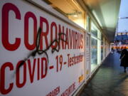 A woman walks past an abandoned coronavirus test center in Frankfurt, Tuesday, Nov. 2, 2021. Numbers of coronavirus infections are rising again in Germany.