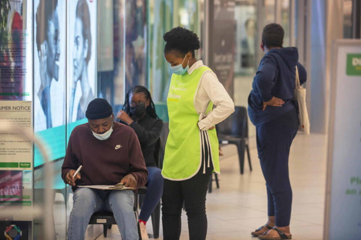 People wait to get vaccinated at a shopping mall, in Johannesburg, South Africa, Friday Nov. 26, 2021. Advisers to the World Health Organization are holding a special session Friday to flesh out information about a worrying new variant of the coronavirus that has emerged in South Africa, though its impact on COVID-19 vaccines may not be known for weeks.