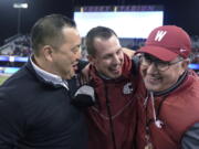 Washington State coach Jake Dickert, center, is joined by athletic director Pat Chun, left, and WSU President Kirk Schultz after WSU defeated Washington 40-13 in an NCAA college football game Friday, Nov. 26, 2021, in Seattle. (AP Photo/Ted S.