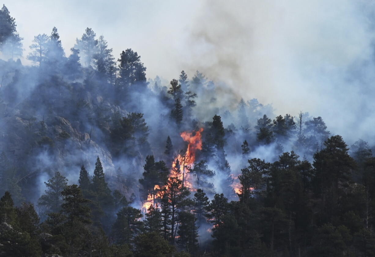 The Kruger Rock fire continues to burn in Estes Park, Colo., on Tuesday, Nov. 16, 2021. A wildfire in the town that serves as a gateway to Rocky Mountain National Park has prompted some residents and businesses to be evacuated. Firefighters said the fire is burning Tuesday near Kruger Rock southeast of downtown Estes Park.