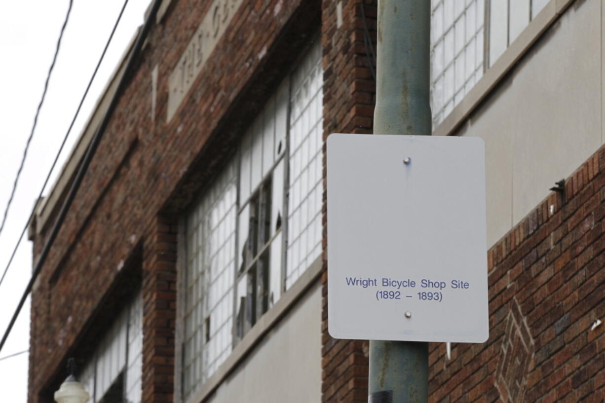 FILE - In this undated photo, a sign notes the site of the Wright brothers' bike shop outside the former Gem City Ice Cream building in Dayton, Ohio.  The Dayton Board of Zoning Appeals has approved the city's request to demolish a 129-year-old historic building that once was the site of the Wright brothers' first bike shop. The city wants to tear down the site because the building has deteriorated to a point where it can no longer be maintained and redeveloped.