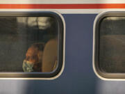 A passenger looks out the window of an Amtrak train at King Street Station on November 15, 2021 in Seattle, Washington. Regional rail is having a resurgence in the U.S.