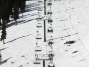 Skiers ride the Rainier Express at Crystal Mountain ski resort Dec. 2, 2020. Washington's biggest ski area is the closest thing to a true resort in the state.