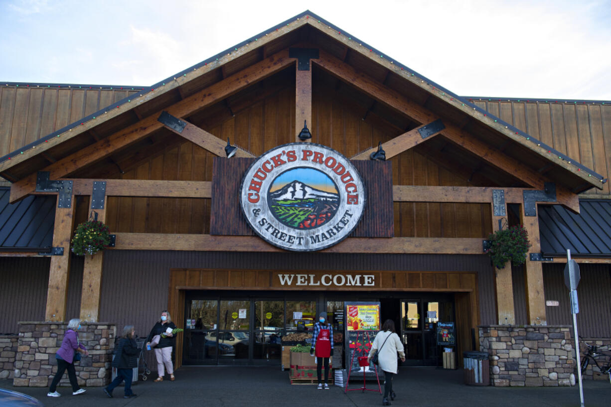 Shoppers come and go outside of Chuck's Produce & Street Market's east Vancouver location on Wednesday morning. Both locations of the popular local grocery store are listed for sale.