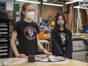 Odyssey Middle School eighth-graders Taryn Cavill, left, and Haley Crowell talk about the Power Pivot on Dec. 1. The team's inclusion of middle-schoolers allows students to get a head start in project-based learning programs like robotics before they start high school.