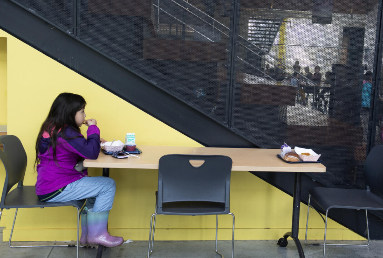 Second-grader Selena Torres enjoys a lunch of chicken, mashed potatoes and corn at Ogden Elementary School on Wednesday morning. Students at Ogden are fed by grade level in 20-minute segments between 11 a.m. and 1 p.m. each day.