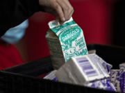 A student grabs a carton of milk during lunchtime at Ogden Elementary School on a Wednesday morning in December. The U.S. Department of Agriculture requires public school districts to fulfill a number of daily nutritional categories, such as dairy, grain, protein and more.