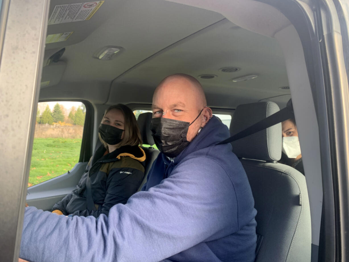 Therapist Lauryn Sanders, left, and peer specialist Reinhardt Ryan ride in Columbia River Mental Health Services' van.