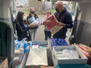 The Columbia River Mental Health Services Mobile Health Team loads its van with supplies before heading out.