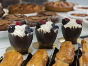 Chocolate mousse cups are among the treats on display at Baron Patisserie. The bakery also sells croissants, Danishes, cinnamon rolls, brioche pastries, cookies, frangipane tarts, dense chocolate cakes and chocolate mousse cakes.