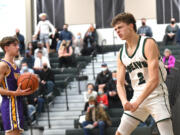 Woodland junior Justin Philpot flexes after a putback dunk Tuesday, Dec. 7, 2021, during the Beavers’ 57-41 win against Columbia River at Woodland High School.