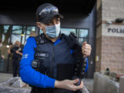 Vancouver bicycle patrol Officer Nicole Vigil displays a hands-free body camera that slips into the front of an officer's vest during a press conference Wednesday afternoon at the Vancouver Police Department's West Precinct. Vancouver police officers are testing out body-worn and dash cameras as a part of the department's 60-day pilot launch of the system.