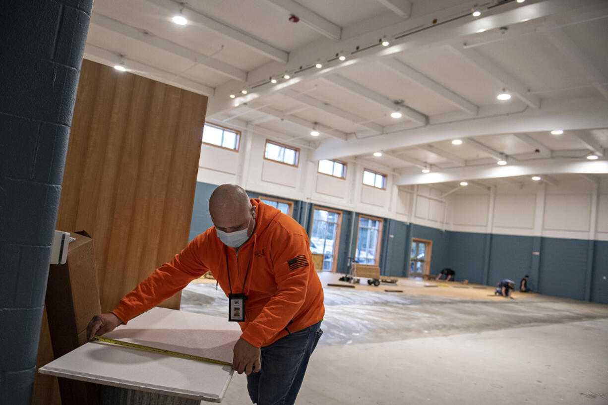 Mario Gonzalez of Inline Commercial Construction helps to bring the student cafe to life for the Vancouver Virtual Learning Academy on Wednesday morning.