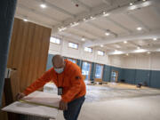 Mario Gonzalez of Inline Commercial Construction helps to bring the student cafe to life for the Vancouver Virtual Learning Academy on Wednesday morning.