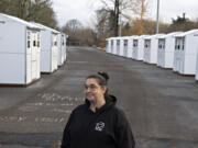 Homelessness Response Coordinator Jamie Spinelli talks with members of the media during a tour of the new Stay Safe Community on Tuesday.  The shelter, the first in a planned series, will accommodate up to 40 residents and will be operated by Outsiders Inn.