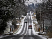 Drivers in Hockinson navigate through a snowy scene after a light blanket of snow dusted the area Monday morning, Dec. 27, 2021.