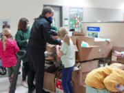 BATTLE GROUND: Student-led donation drives filled trucks with thousands of pounds of food and other items for local food banks, giving trees provided gifts for families in need, and drive-through holiday celebrations saw long lines at several schools.