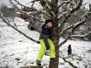 Kemper Aubrey of Vancouver pauses to enjoy a quiet moment away from the sledding hill while joining friends at a park in Felida's Ashley Heights neighborhood on Tuesday morning, Dec. 28, 2021. The winter storm dropped between 1 and 2 inches of snow on the city.