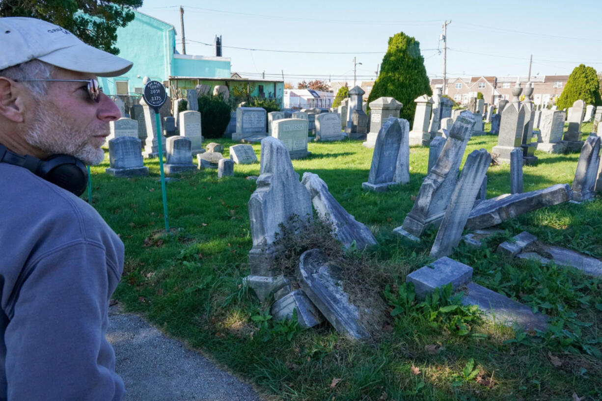 Gravestone conservator Joe Ferrannini at the Har Nebo Cemetery in Philadelphia's Oxford Circle neighborhood. He is repairing and resetting monuments there as a pilot program the Jewish Federation of Greater Philadelphia hopes will provide a model for conservation at other Jewish burial grounds in and around the city.