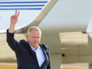 New LSU football coach Brian Kelly gestures to fans after his arrival at Baton Rouge Metropolitan Airport, Tuesday, Nov. 30, 2021, in Baton Rouge, La. Kelly, formerly of Notre Dame, is said to have agreed to a 10-year contract with LSU worth $95 million plus incentives.