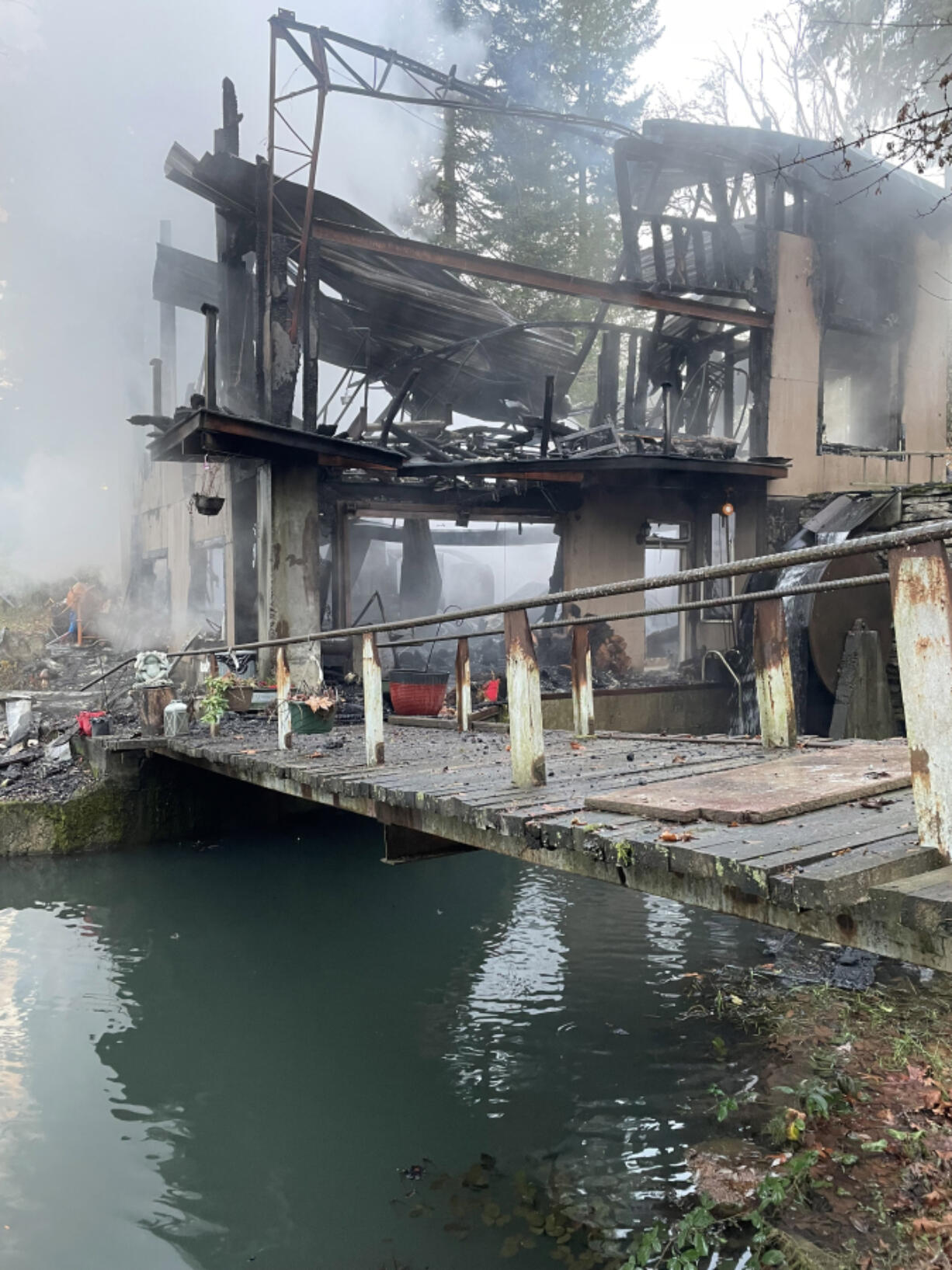 A hazardous structure on a property east of La Center burned down Friday morning after neighbors reported hearing explosions coming from the building. Fire crews determined the explosions were propane tanks and ammunition stored inside.