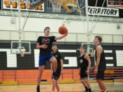 Battle Ground sophomore Tait Spencer, left, goes for a layup during a scrimmage on Wednesday, Dec. 22, at Battle Ground High School.