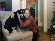 Anne Burrows poses for a portrait with her dog Ruby at her home Tuesday, Dec. 7, 2021, in Ben Avon, Pennsylvania.