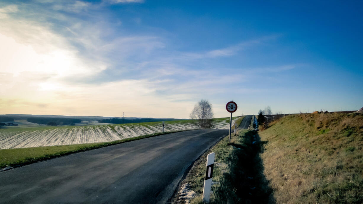 Lonely street with traffic sign 50kmh