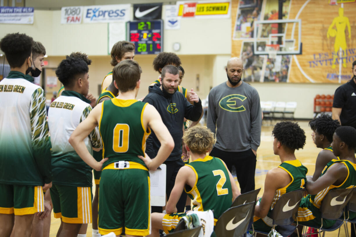 Evergreen coach Brett Henry talks to his team during a break in action against Sherwood on Wednesday at the Les Schwab Invitational in Hillsboro. The Plainsmen received an invite to the prestigous tournament on Christmas, one day before it started.