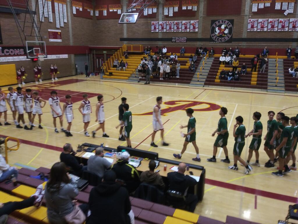 Prairie and Reynolds players shake hands after Reynolds' 64-50 win over Prairie in a boys basketball game at Prairie (Tim Martinez/The Columbian)