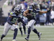 Seattle Seahawks middle linebacker Bobby Wagner (54) runs with the ball after intercepting a pass against the San Francisco 49ers during the first half of an NFL football game, Sunday, Dec. 5, 2021, in Seattle.