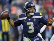 Seattle Seahawks quarterback Russell Wilson looks to pass against the San Francisco 49ers during the second half of an NFL football game, Sunday, Dec. 5, 2021, in Seattle.