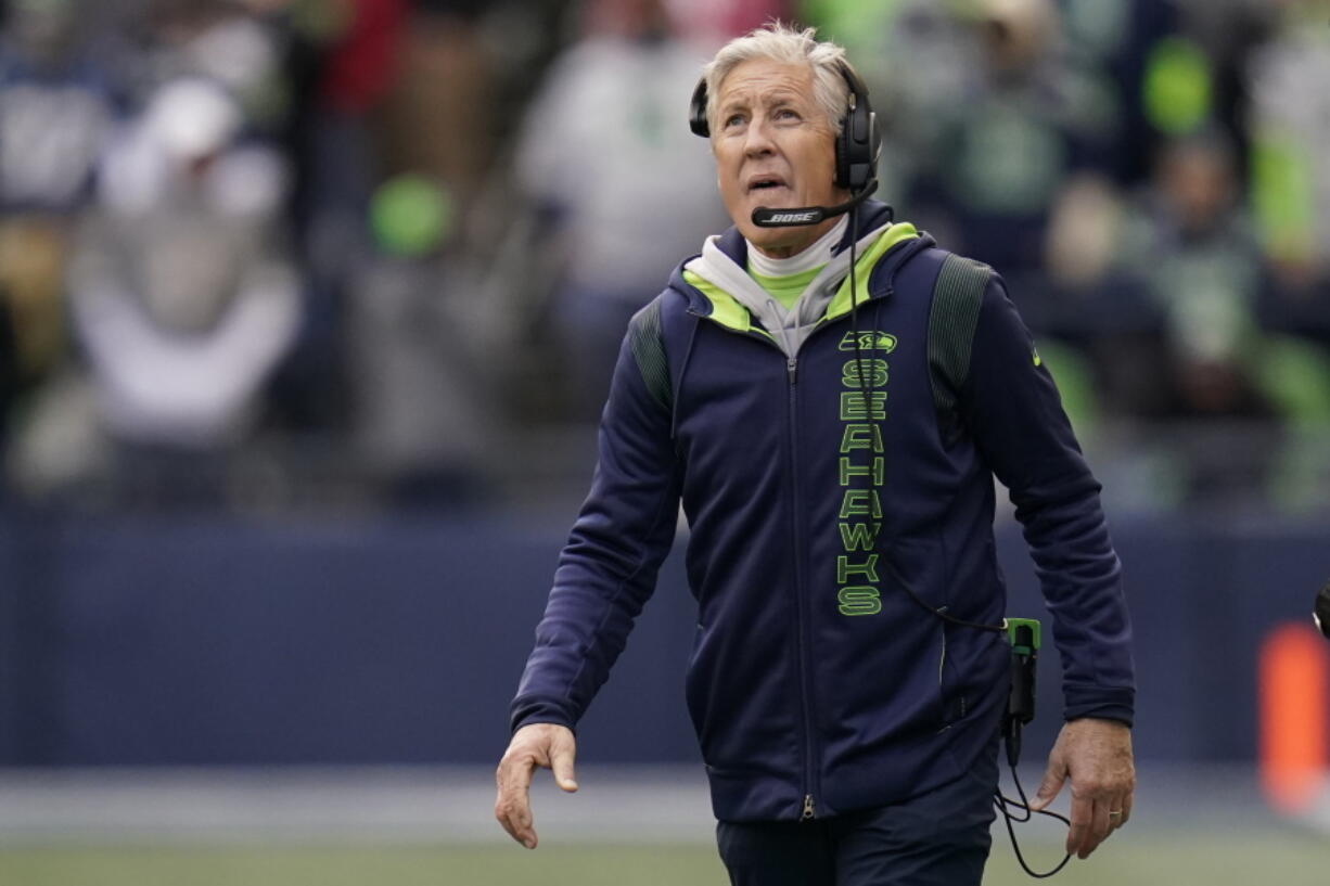 Seattle Seahawks head coach Pete Carroll looks toward the scoreboard during the first half of an NFL football game against the San Francisco 49ers, Sunday, Dec. 5, 2021, in Seattle.