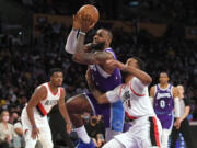 Los Angeles Lakers forward LeBron James (6) gets past Portland Trail Blazers forward Norman Powell (24) during the first half of an NBA basketball game Friday Dec. 31, 2021, in Los Angeles.