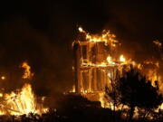 Homes burn as a wildfire rips through a development near Rock Creek Village, Thursday, Dec. 30, 2021, near Broomfield, Colo. An estimated 580 homes, a hotel and a shopping center have burned and tens of thousands of people were evacuated in wind-fueled wildfires outside Denver, officials said Thursday evening.