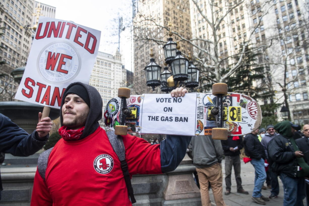 Vincent Palma, a plumber and gas fitter from local union #1, protests against climate activists from the #GasFreeNYC coalition who are rallying and holding a news conference in City Hall Park, on Dec. 15, 2021, in New York. A new poll from MTV and The Associated Press-NORC Center for Public Affairs Research shows a broader trend among millennials and Generation Z who say they are more likely to be optimistic about the future and their ability to create change than their older counterparts.