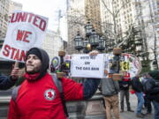 Vincent Palma, a plumber and gas fitter from local union #1, protests against climate activists from the #GasFreeNYC coalition who are rallying and holding a news conference in City Hall Park, on Dec. 15, 2021, in New York. A new poll from MTV and The Associated Press-NORC Center for Public Affairs Research shows a broader trend among millennials and Generation Z who say they are more likely to be optimistic about the future and their ability to create change than their older counterparts.