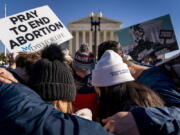 FILE - A group of anti-abortion protesters pray together in front of the U.S. Supreme Court, Dec. 1, 2021, in Washington, as the court hears arguments in a case from Mississippi, where a 2018 law would ban abortions after 15 weeks of pregnancy, well before viability. As the Supreme Court court weighs the future of the landmark 1973 Roe v. Wade decision, a resurgent anti-abortion movement is looking to press its advantage in state-by-state battles while abortion-rights supporters prepare to play defense.