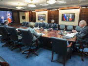 In this image provided by The White House, President Joe Biden speaks as he meets virtually via a secure video conference with Russian President Vladimir Putin from the Situation Room at the White House in Washington, Tuesday, Dec. 7, 2021. At far left is White House national security adviser Jake Sullivan along with Secretary of State Antony Blinken, right, national security council senior director for Russian and Central Asia, Eric Green.