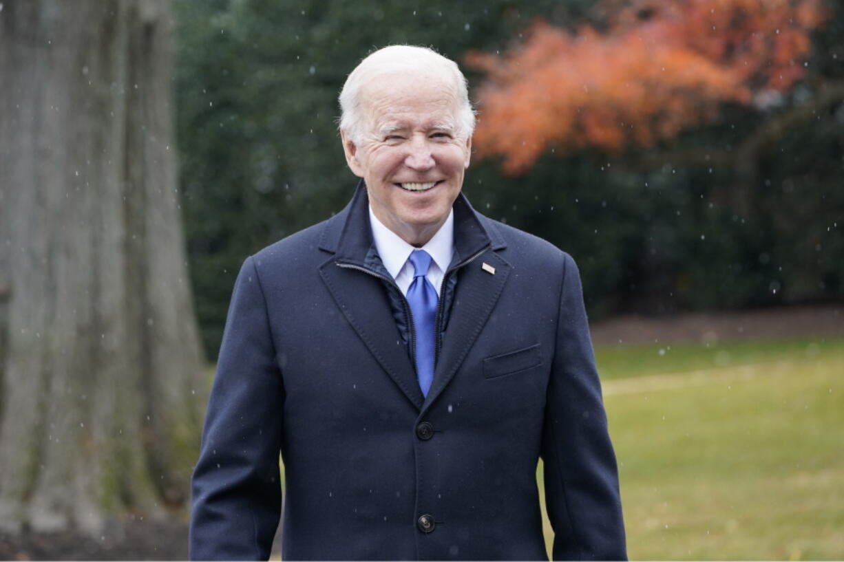 President Joe Biden talks with reporters at the White House in Washington, Wednesday, Dec. 8, 2021, during snow flurries, as heads to Missouri to promote the bipartisan infrastructure law.