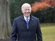 President Joe Biden talks with reporters at the White House in Washington, Wednesday, Dec. 8, 2021, during snow flurries, as heads to Missouri to promote the bipartisan infrastructure law.