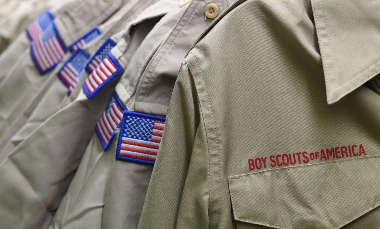 FILE - In this Feb. 18, 2020, file photo, Boy Scouts of America uniforms are displayed in a retail store at the headquarters for the French Creek Council of the Boy Scouts of America in Summit Township, Pa. In an agreement announced Monday, Dec. 13, 2021, attorneys in the Boy Scouts of America bankruptcy have reached a tentative settlement under which one of the organization's largest insurers would contribute $800 million into a fund for victims of child sexual abuse.