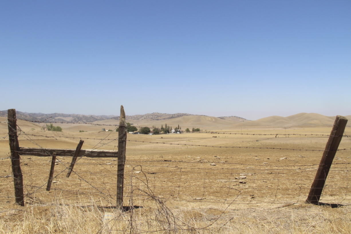 FILE - A barbed wire fence runs along a ranch in Sites, Calif., on July 23, 2021. This ranch would be underwater once the Sites Reservoir is completed. On Wednesday, Dec. 15, 2021, the California Water Commission voted to advance what could be California's first new major reservoir in decades. Wednesday's vote is a big step for the project to receive more than $800 million in taxpayer funding, or about 20% of the total cost of the project.