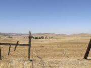 FILE - A barbed wire fence runs along a ranch in Sites, Calif., on July 23, 2021. This ranch would be underwater once the Sites Reservoir is completed. On Wednesday, Dec. 15, 2021, the California Water Commission voted to advance what could be California's first new major reservoir in decades. Wednesday's vote is a big step for the project to receive more than $800 million in taxpayer funding, or about 20% of the total cost of the project.