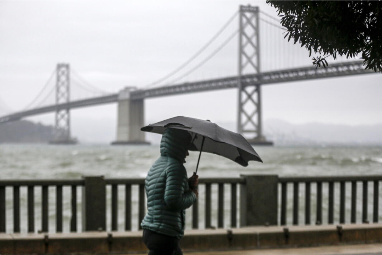 A cold weather front brings clouds skies and rainstorms to downtown San Francisco, Calif., on Sunday, Dec. 12, 2021. Meteorologists say the storms are just the beginning of an "atmospheric river" that will bring more intense rainfall and heavy snow in the Sierras. A significant storm ramped up Sunday with snow in Northern California that forced drivers to wrap their tires in chains and light rain in the lower elevations. The storm promises to drop up to 8 feet of snow on the highest peaks and drench other parts of the state. (Bront?