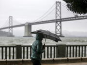 A cold weather front brings clouds skies and rainstorms to downtown San Francisco, Calif., on Sunday, Dec. 12, 2021. Meteorologists say the storms are just the beginning of an "atmospheric river" that will bring more intense rainfall and heavy snow in the Sierras. A significant storm ramped up Sunday with snow in Northern California that forced drivers to wrap their tires in chains and light rain in the lower elevations. The storm promises to drop up to 8 feet of snow on the highest peaks and drench other parts of the state. (Bront?