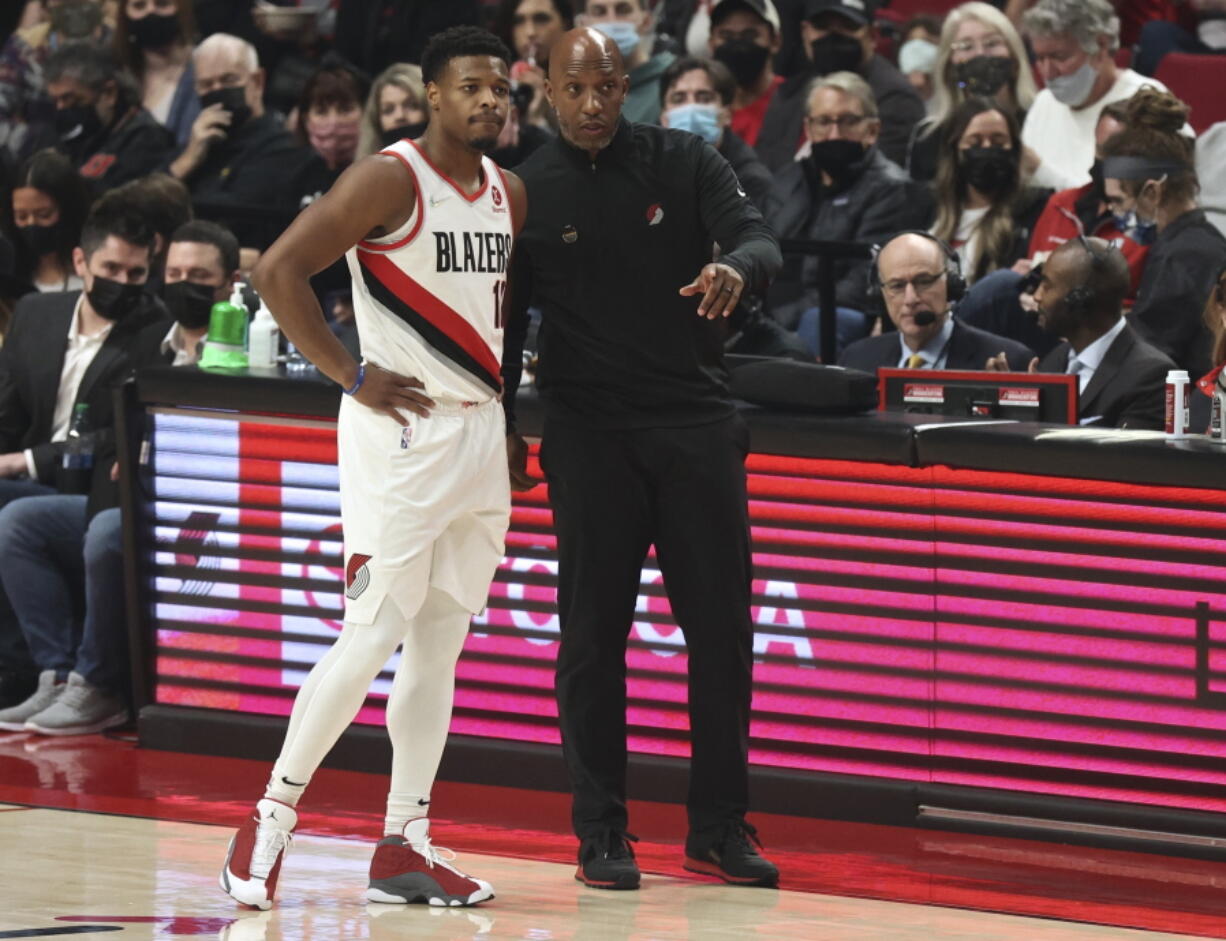 Portland Trail Blazers coach Chauncey Billups, right, talks to guard Dennis Smith Jr., left, during the first half of the team's NBA basketball game against the Boston Celtics in Portland, Ore., Saturday, Dec. 4, 2021.