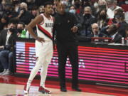 Portland Trail Blazers coach Chauncey Billups, right, talks to guard Dennis Smith Jr., left, during the first half of the team's NBA basketball game against the Boston Celtics in Portland, Ore., Saturday, Dec. 4, 2021.