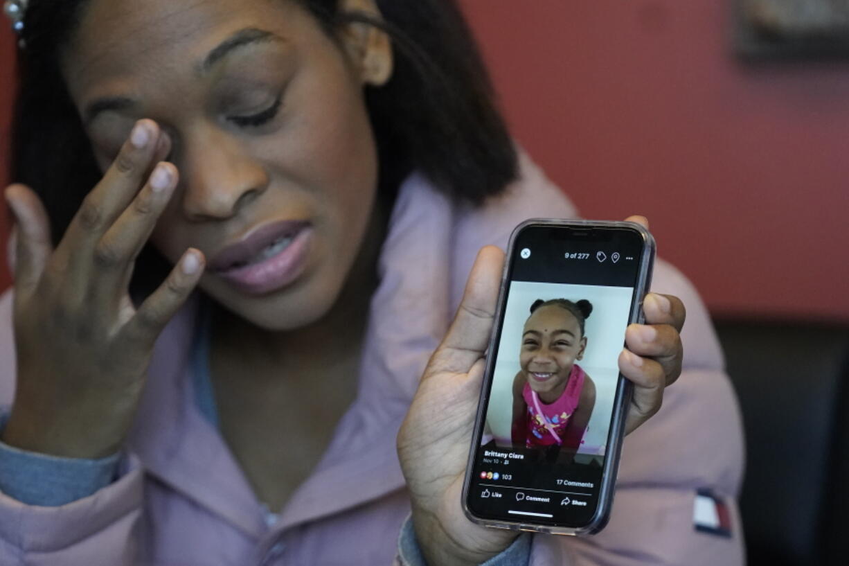 Brittany Tichenor-Cox, holds a photo of her daughter, Isabella "Izzy" Tichenor, during an interview Monday, Nov. 29, 2021, in Draper, Utah. Tichenor-Cox said her 10-year-old daughter died by suicide after she was harassed for being Black and autistic at school. She is speaking out about the school not doing enough to stop the bullying.